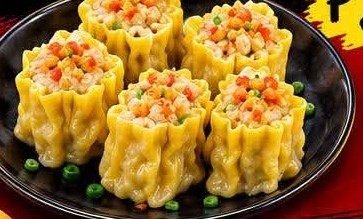 A plate of five golden siomai dumplings